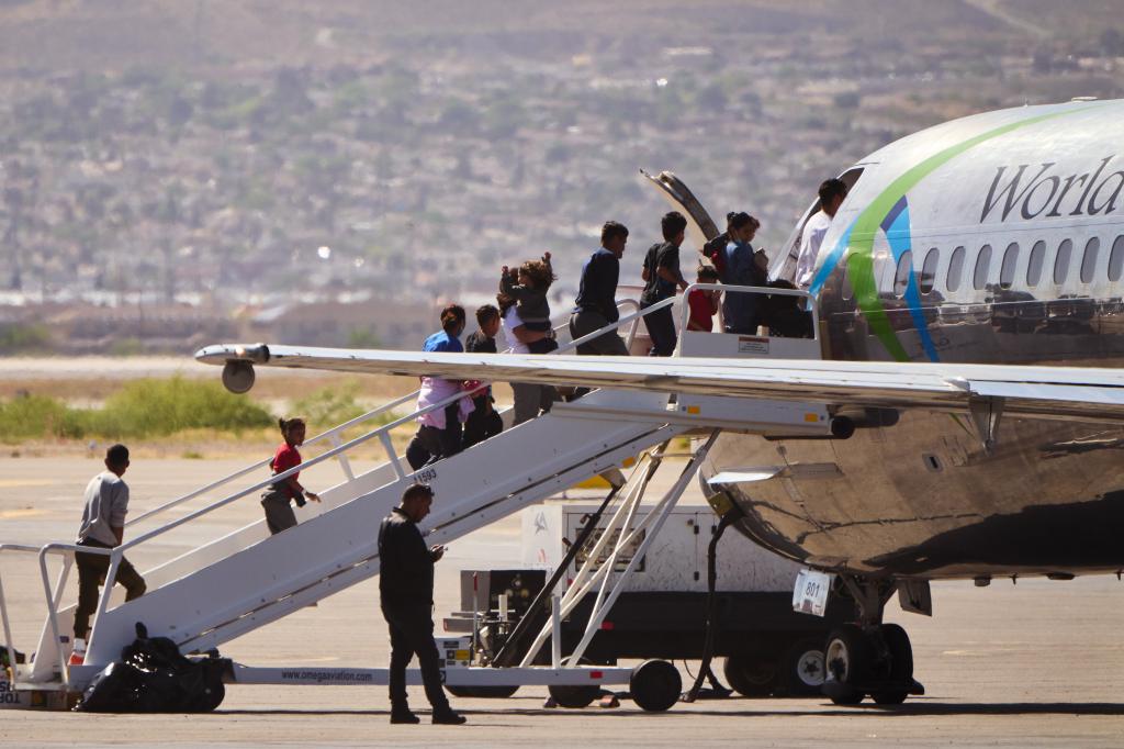 Immigrants board a World Atlantic flight at El Paso International Airport Wednesday, April 19, 2023 in El Paso, Texas.